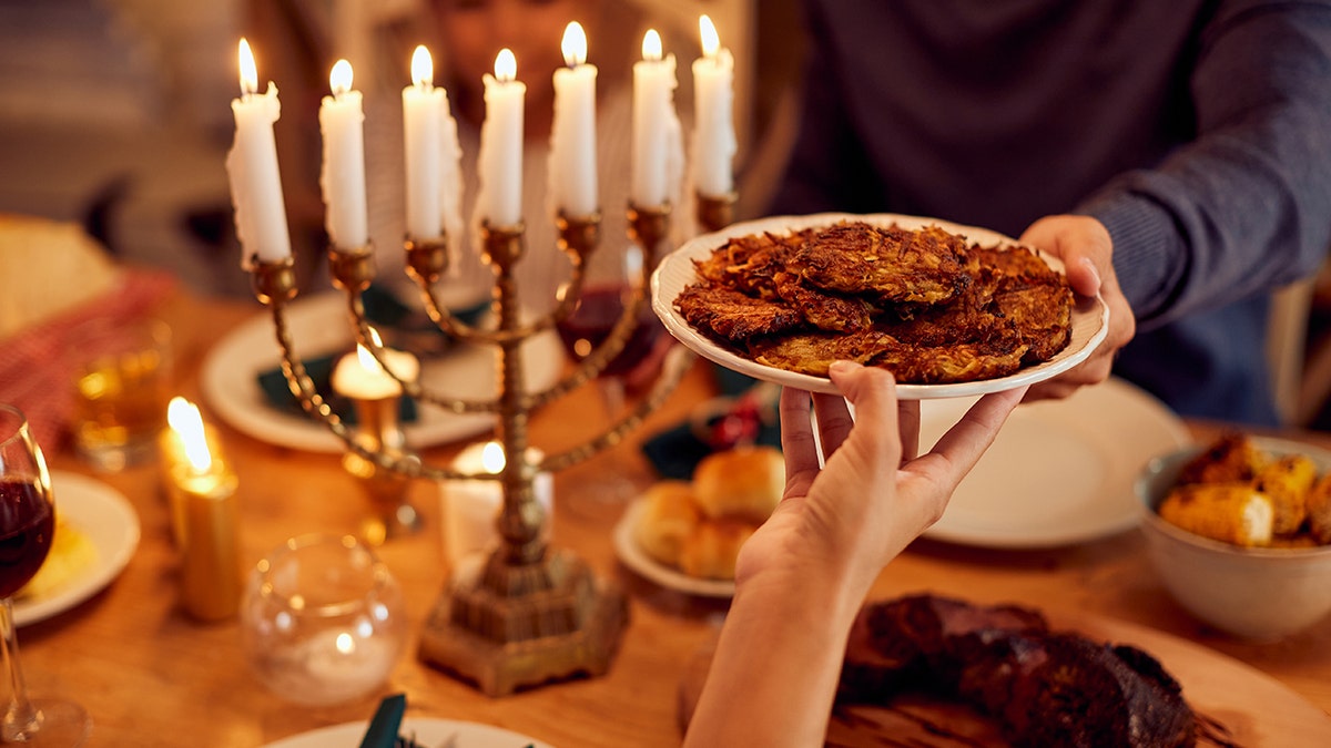 Latkes passed around table during Hanukkah