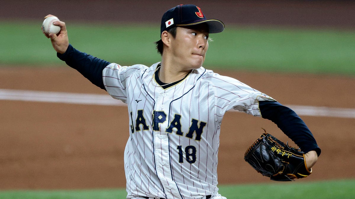 Yoshinobu Yamamoto pitches